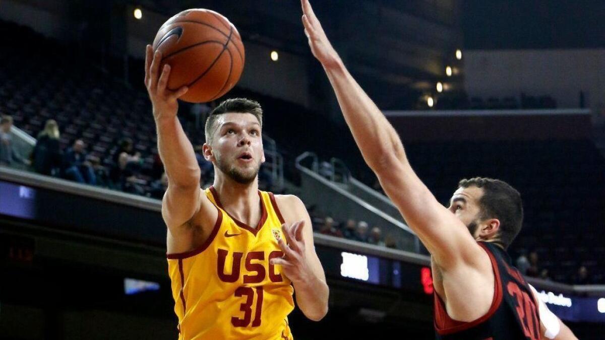 USC's Nick Rakocevic, shooting against Stanford's Josh Sharma this month, has much better stats at home than on the road.