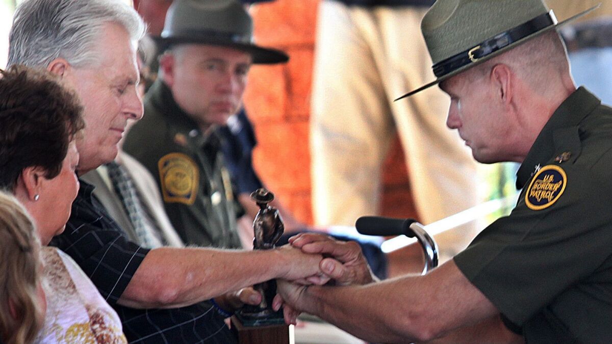 Kent Terry Sr., father of Border Patrol Agent Brian Terry, and Richard "Rick" Barlow, chief patrol agent of the Tucson sector, share a quiet moment during the dedication ceremony for a new station named after Brian Terry on Sept. 18, 2012 on Naco, Ariz.