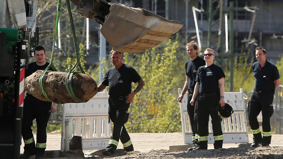 A bomb disposal team removes an unexploded 1,000-pound World War II-era bomb discovered earlier this year in Berlin.