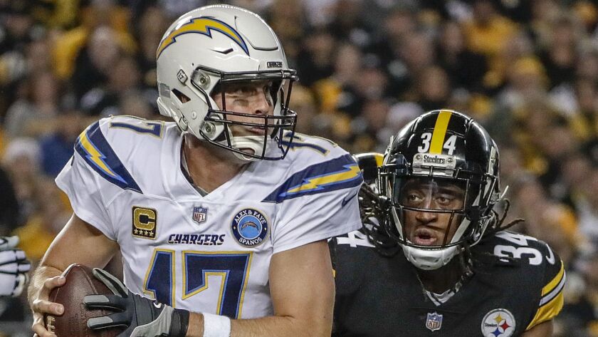Chargers quarterback Philip Rivers tries to elude Steelers safety Terrell Edmunds.