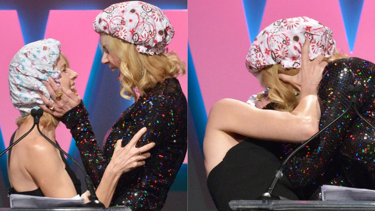 Having put on shower caps, actresses Naomi Watts, left, and Nicole Kidman pucker up on stage at the Women in Film’s Crystal + Lucy Awards in Century City on Tuesday.
