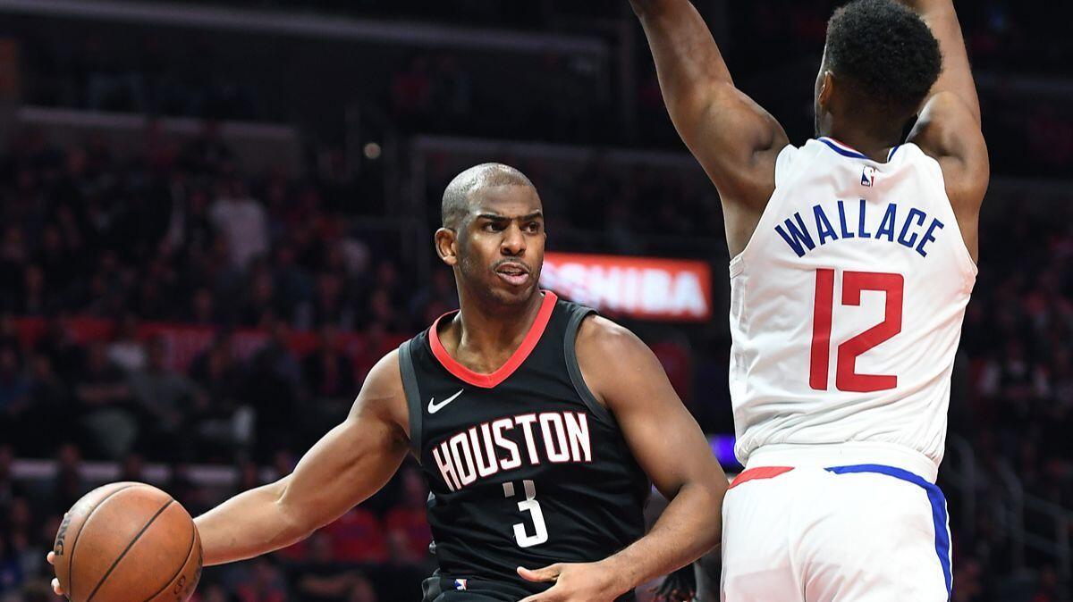 Houston Rockets' Chris Paul (3) gets off a pass in front of Clippers' Tyrone Wallace (12) in the fourth quarter at the Staples Center on Monday.