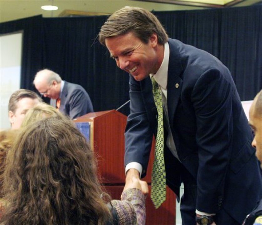 Two-time presidential candidate John Edwards, foreground, and former White House Chief of Staff Karl Rove, background, interact with the audience after a post-election discussion at the Commercial Finance Association's 64th Annual Convention, Thursday, Nov. 13, 2008 in San Francisco. (AP Photo/George Nikitin)