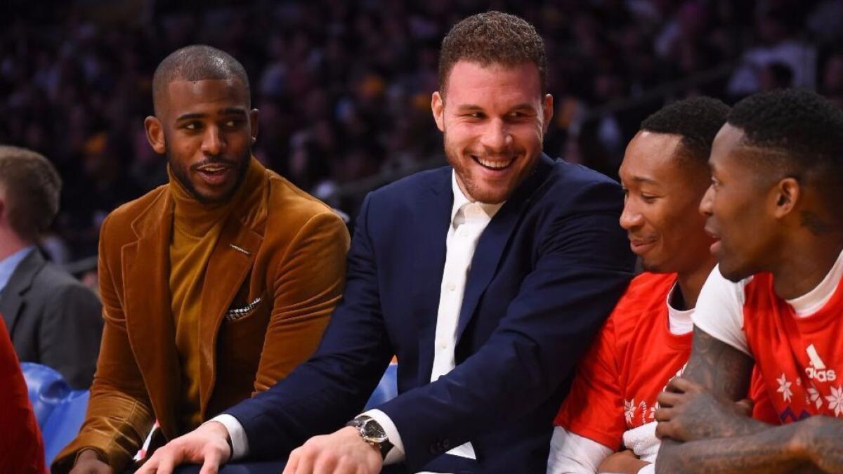 Clippers Chris Paul and Blake Griffin talk with Wesley Johnson and Jamal Crawford during a game against the Lakers on Dec. 25.