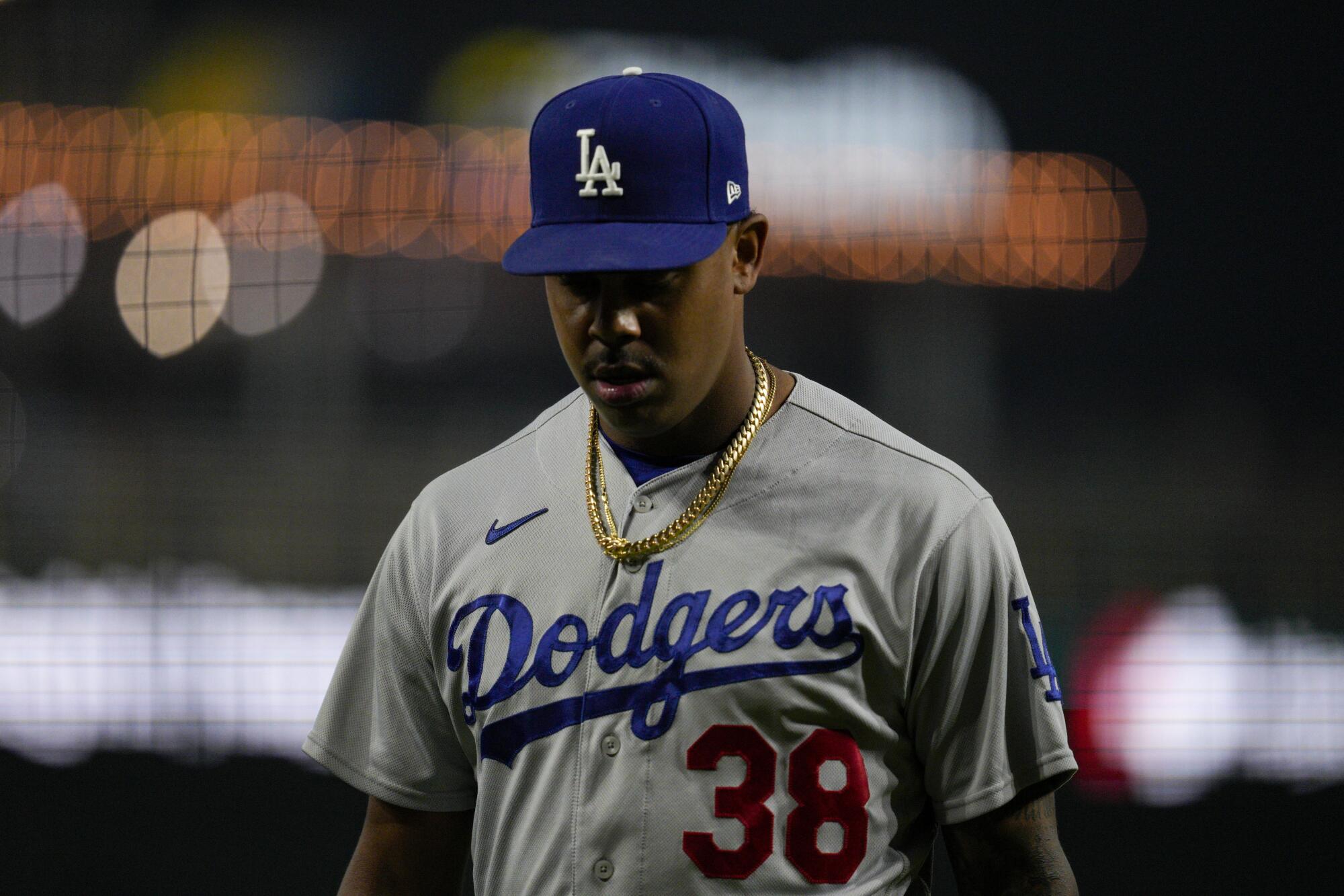 Dodgers relief pitcher Yency Almonte walks to the dugout during a loss to the Cincinnati Reds on June 7.