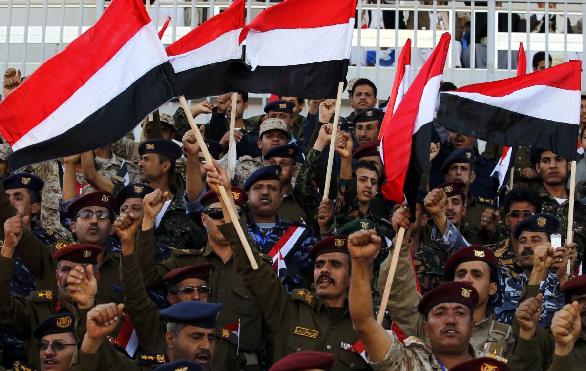 Yemeni army officers loyal to the Houthi rebels wave Yemeni flags Feb. 7 at a celebration of a new constitutional declaration by the Shiite Muslim group.