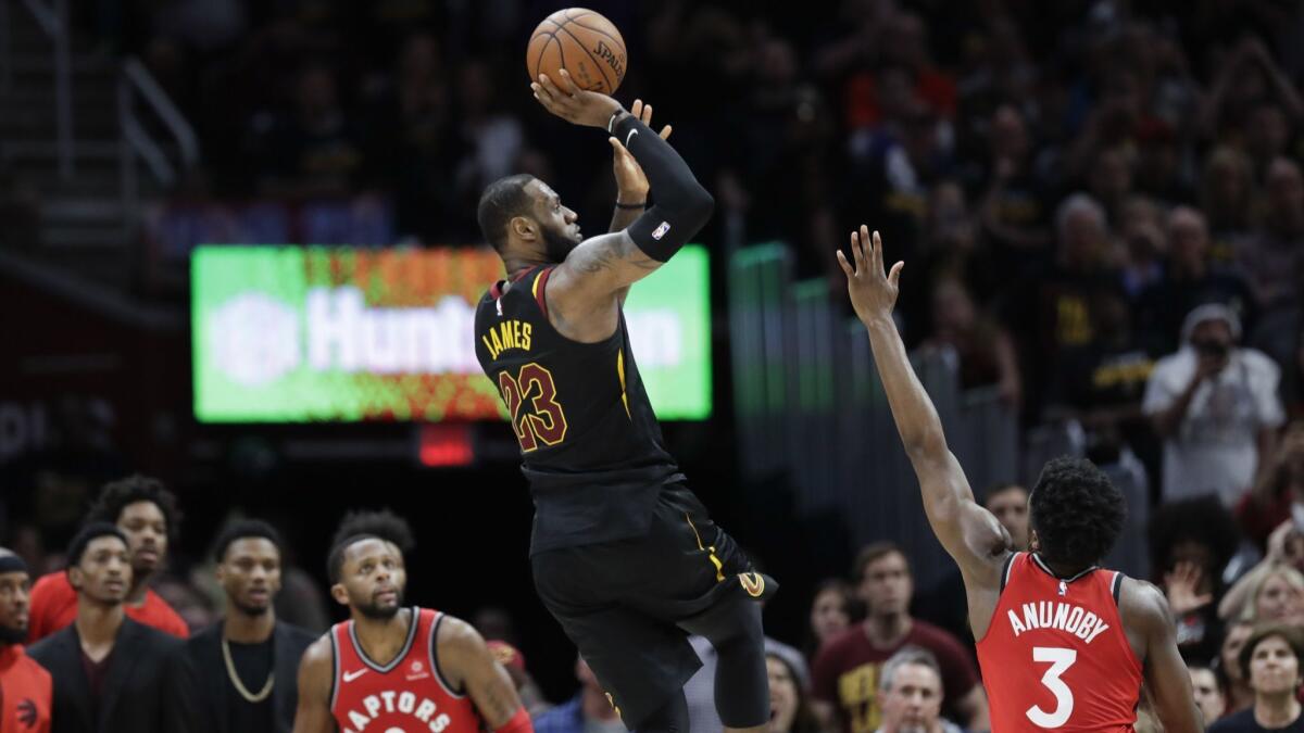 LeBron James hits the game-winning shot as Toronto Raptors' OG Anunoby (3) and CJ Miles (0) watch