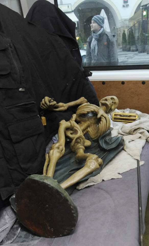 The statue of Death lies in a car after being removed from the clock.