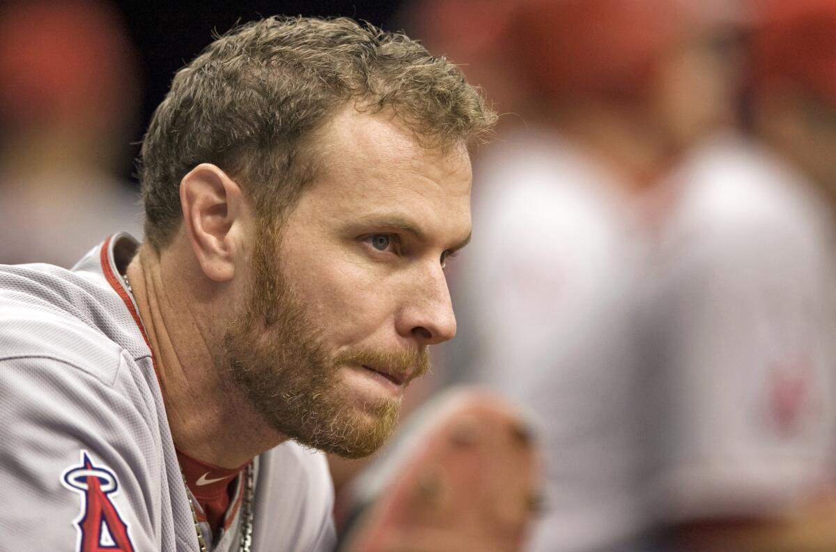 Josh Hamilton watches from the dugout during a baseball game against the Tampa Bay Rays in August.