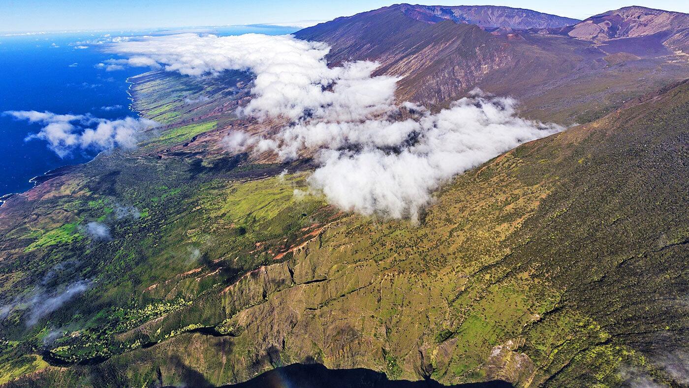 Maui, seen here from the south, ascends the flanks of towering Mt. Haleakala into what's known as Upcountry and its bucolic landscape of farms and ranches.