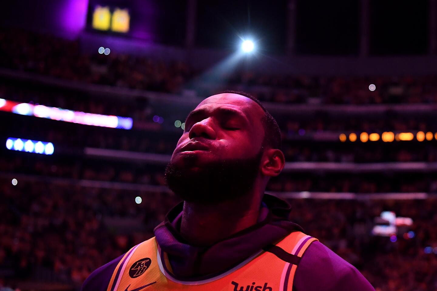 Lakers star LeBron James listens to the the national anthem during a pregame ceremony honoring the life of Kobe Bryant at Staples Center on Jan. 31, 2020.