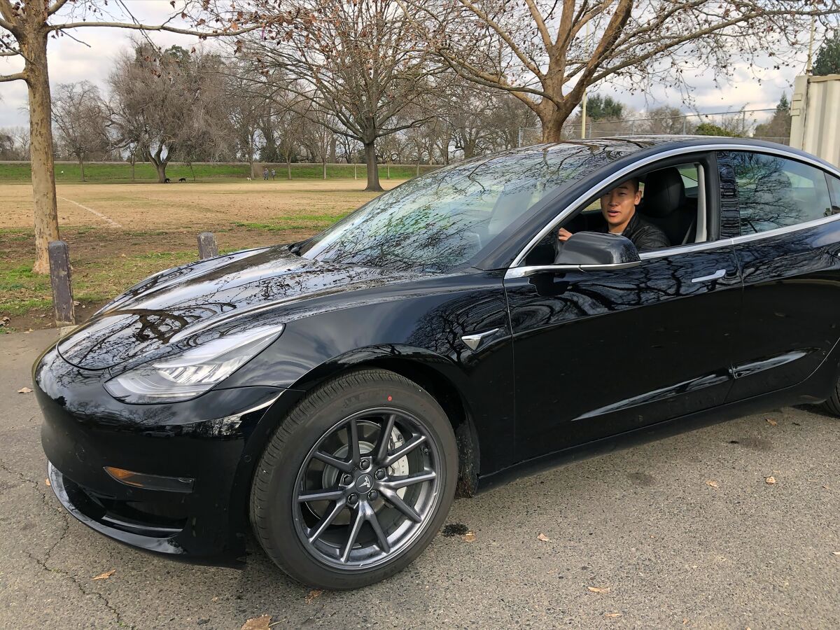 Ethan Dang in his 2019 Tesla Model 3. He does peer-to-peer car sharing through Turo.