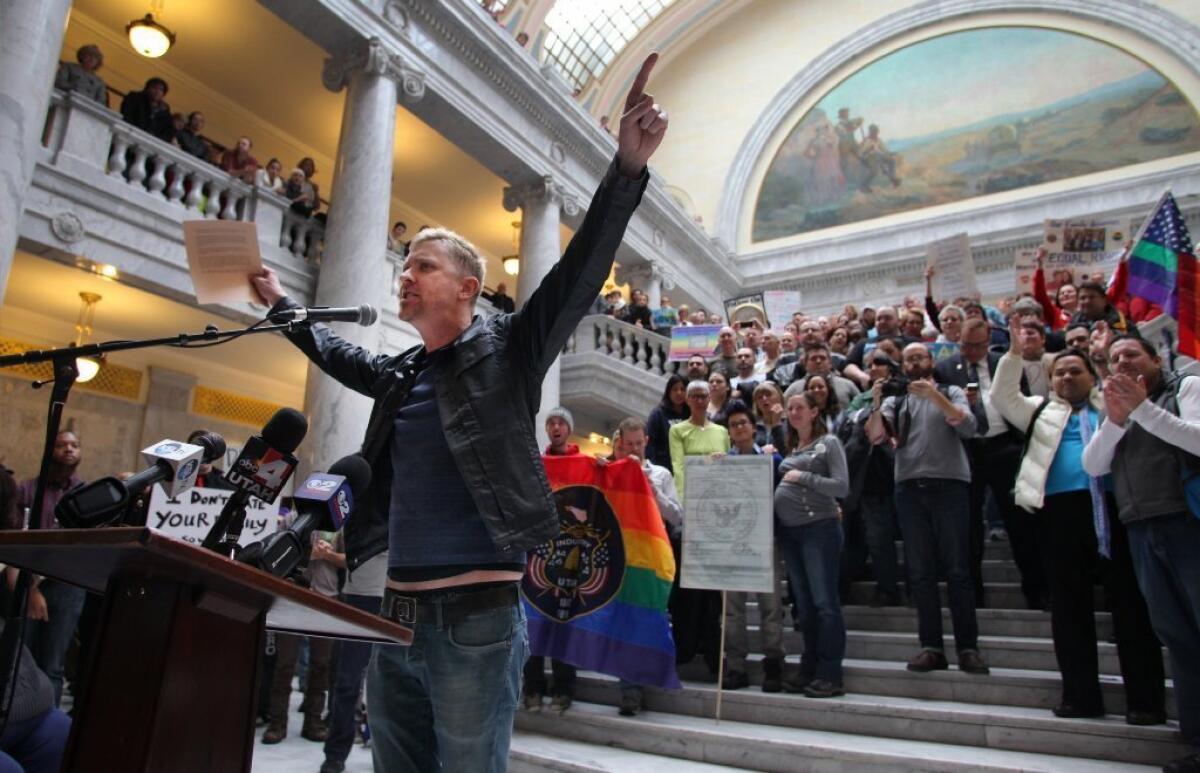 Troy Williams, a local LGBT organizer, speaks to supporters of gay marriage as they gathered to rally and deliver more than 58,000 signatures to Utah Gov. Gary Herbert at the state Capitol in Salt Lake City.