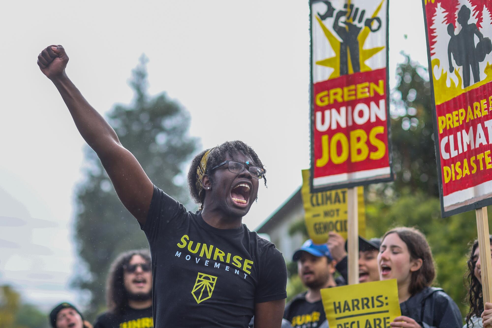 Protesters hold signs reading "Green union jobs" and "Prepare for climate disaster."