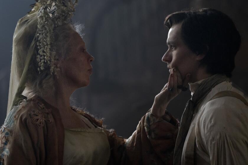 Olivia Colman, left, as Miss Havisham, and Fionn Whitehead as Pip in "Great Expectations."