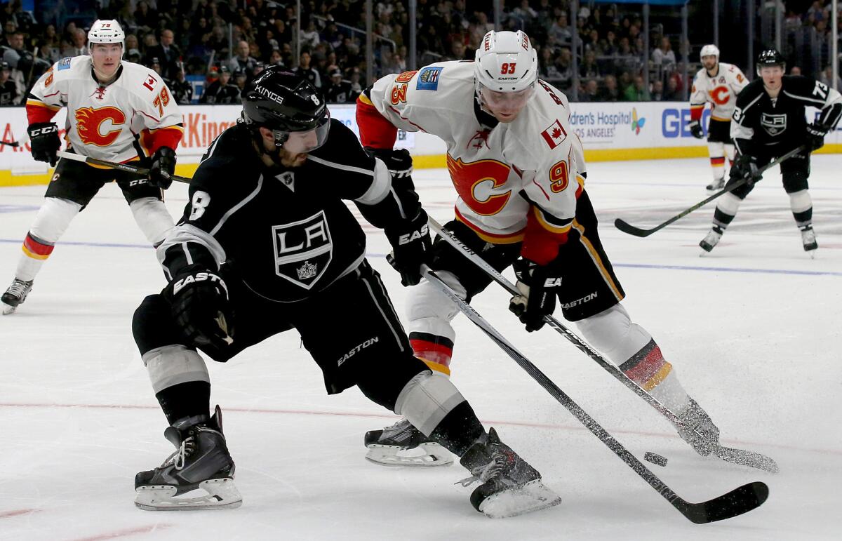 Kings defenseman Drew Doughty fights for control of the puck with Flames forward Sam Bennett during the second period of a game on March 31.