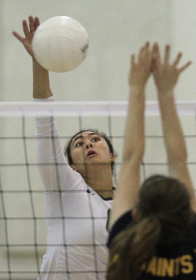 Sage Hill School's Kekai Whitford spikes the ball at Crean Lutheran's Danielle Straka during the first set in a CIF State Southern California Regional Division III semifinal match on Saturday. The Lightning beat the Saints in three straight sets.