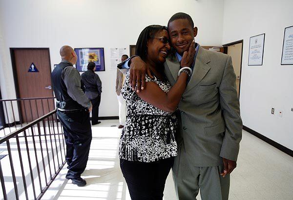 A proud Michelle Thompson hugs her son, Mario Farmer, 21, before graduation at the Day Reporting Center. See full story
