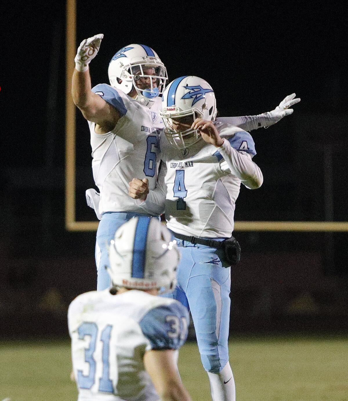 Corona del Mar's John Humphreys (6) jumps into quarterback Ethan Garbers after catching a 65-yard touchdown pass against Alemany in a CIF Southern Section Division 3 semifinal playoff game in Mission Hills on Nov. 22.