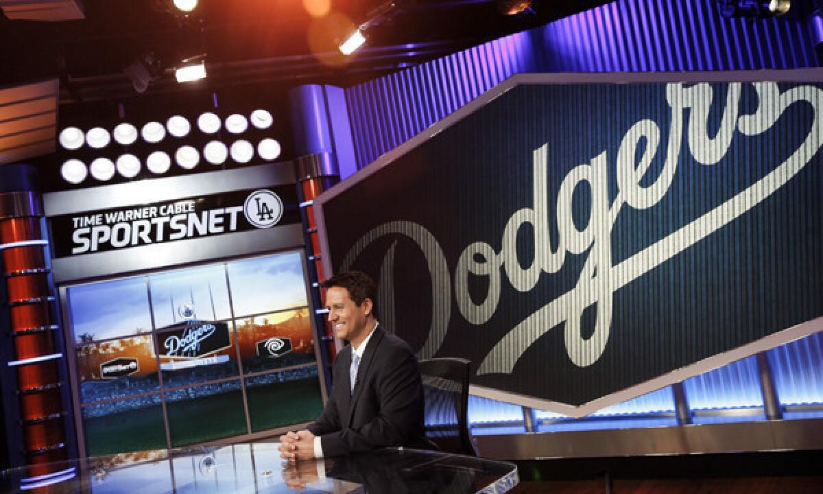 Anchor John Hartung sits in the SportsNet LA studio in El Segundo days before the network's official launch on Feb. 25. Not every Dodgers fan is cheering for the team's new cable channel.