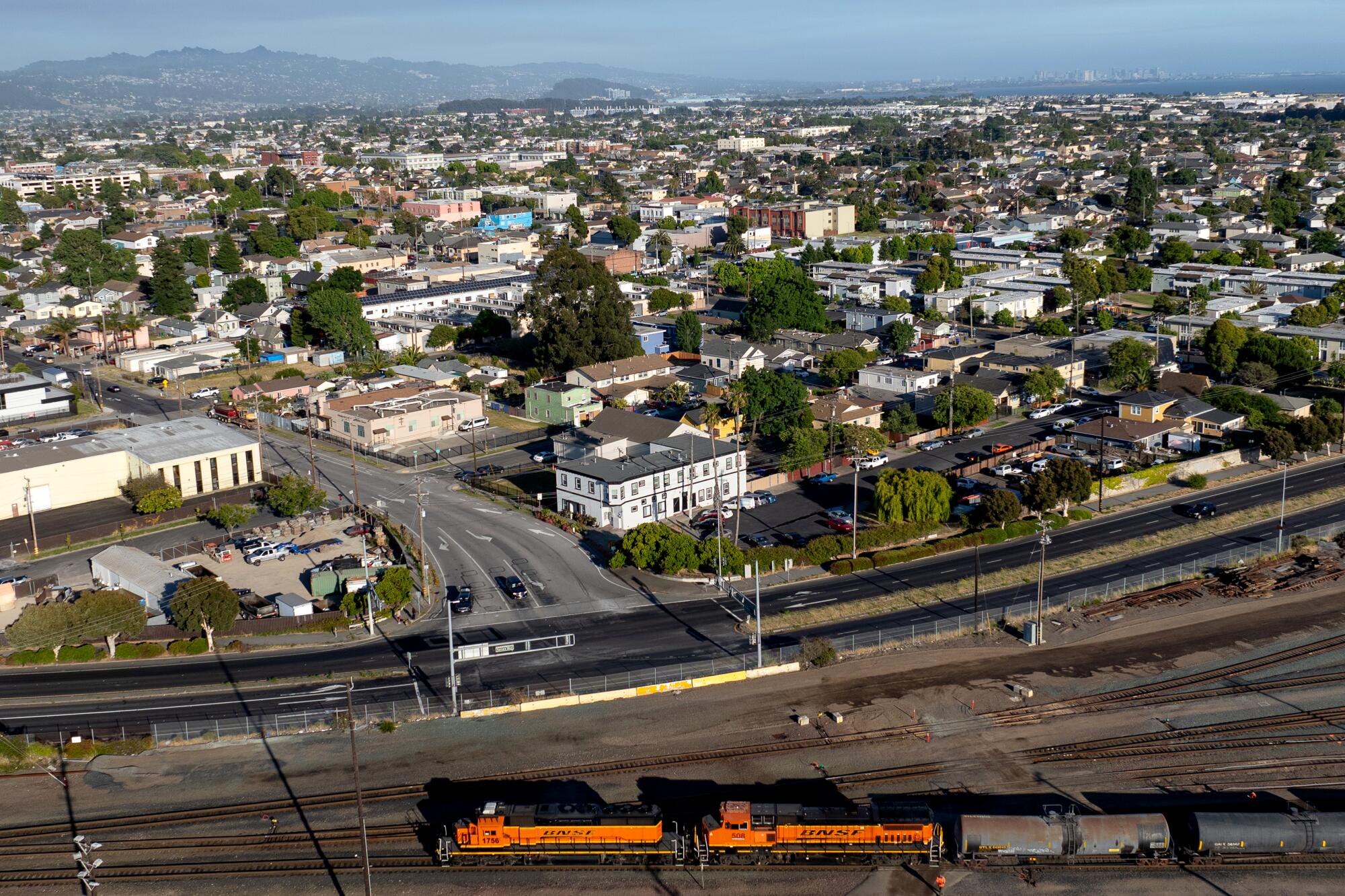An aerial view of a city with a train in the foreground.   