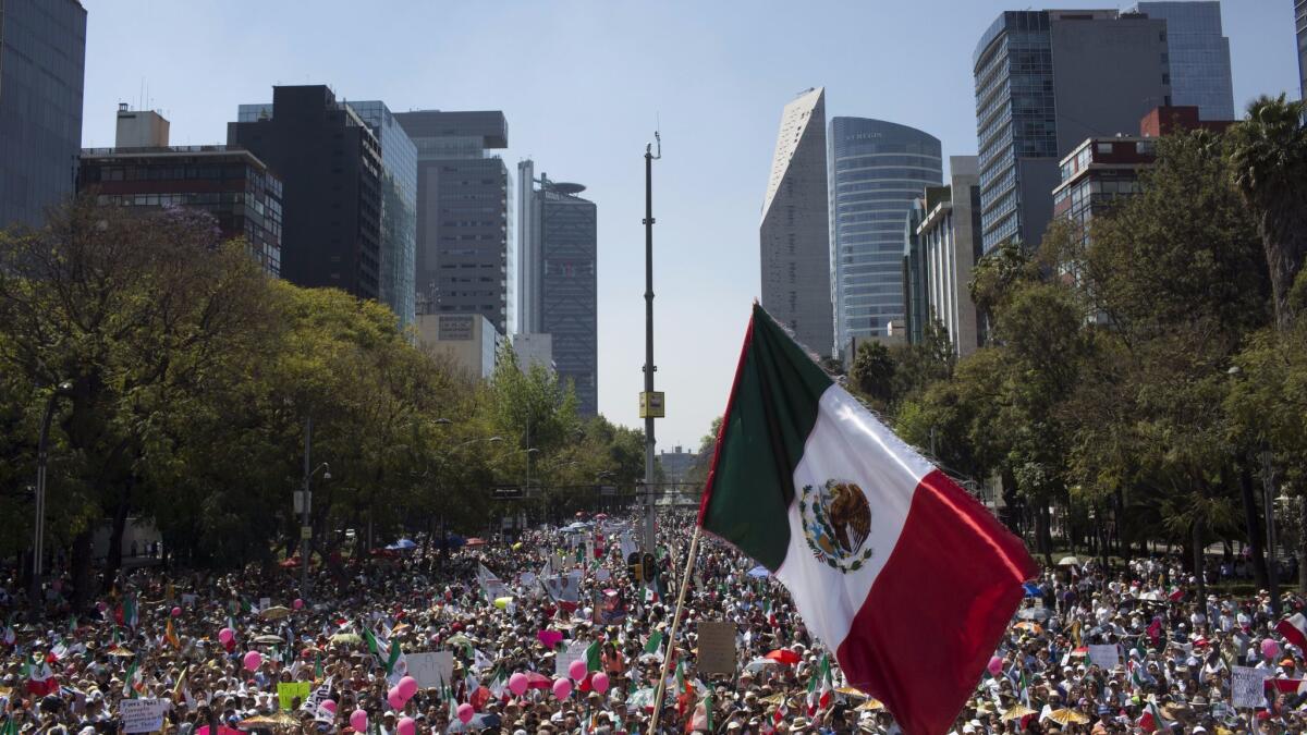 Demonstrators opposed to the policies of President Trump and Mexican President Enrique Peña Nieto march to the Plaza Angel Independencia in Mexico City on Feb. 12.