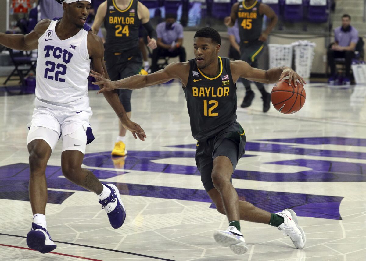 TCU guard RJ Nembhard (22) defends as Baylor guard Jared Butler (12) drives the ball in the second half of an NCAA college basketball game, Saturday, Jan. 9, 2021, in Fort Worth, Texas. (AP Photo/ Richard W. Rodriguez)