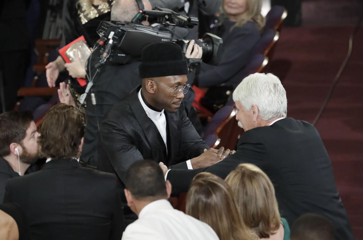 Mahershala Ali, winner of the Oscar for actor in a supporting role, shakes hands with fellow nominee Sam Elliott during the 91st Academy Awards on Sunday.