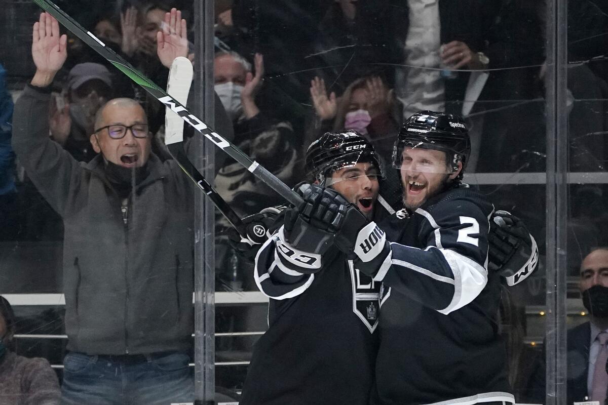 Kings defenseman Alexander Edler celebrates his goal with right wing Alex Iafallo.