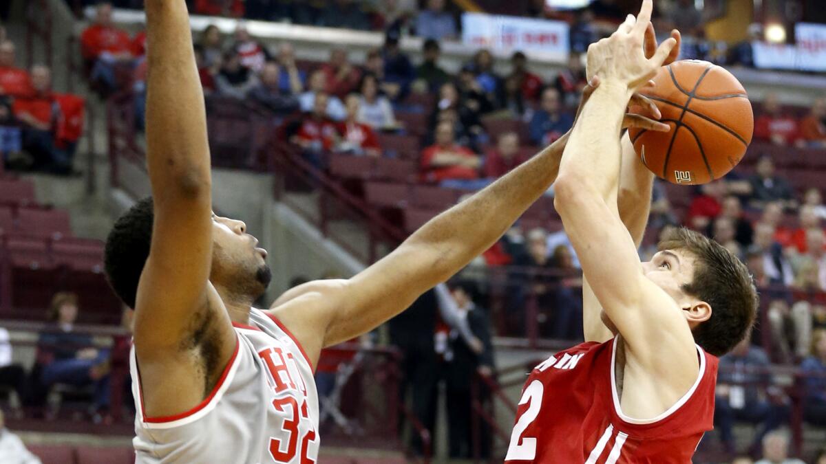 Ohio State's Trevor Thompson blocks a shot by Wisconsin's Ethan Happ during the first half Thursday night.