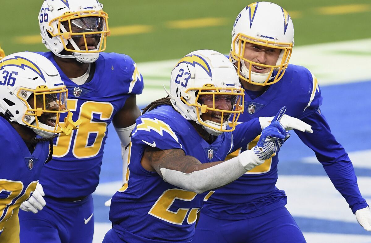 Chargers safety Rayshawn Jenkins reacts with his teammates after intercepting a pass in the end zone.