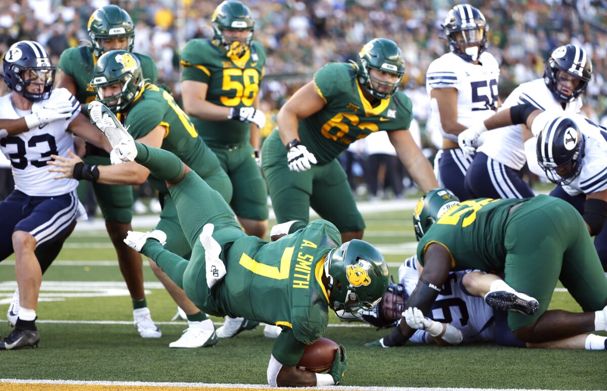Baylor running back Abram Smith (7) dives for a touchdown against BYU during the second half of an NCAA college football game, Saturday, Oct. 16, 2021, in Waco, Texas. Baylor won 38-24. (AP Photo/Ron Jenkins)