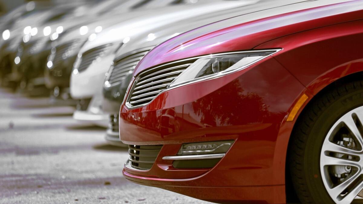A Lincoln MKZ sits at a dealership.