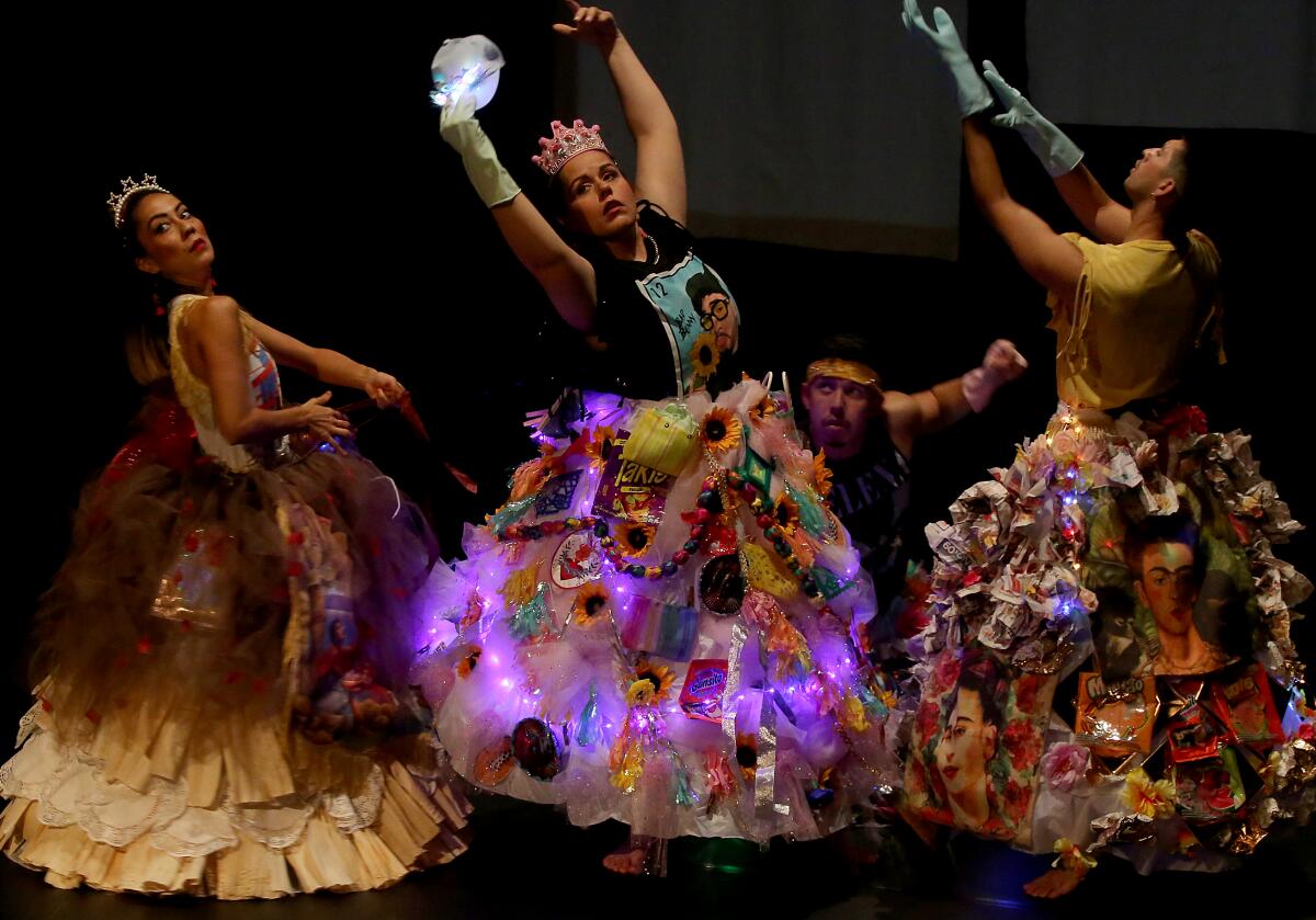 Performers are clad in broad skirts onto which are pinned lights, flowers and images of Frida Kahlo.