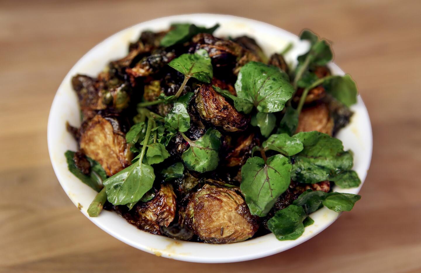 Sweet & Spicy Brussels Sprouts are made with garum, pecans and garlic confit. Perhaps because of their Australian origins, restauranteur Jud Mongell and chef Ken Addington often garnish their dishes with nuts.