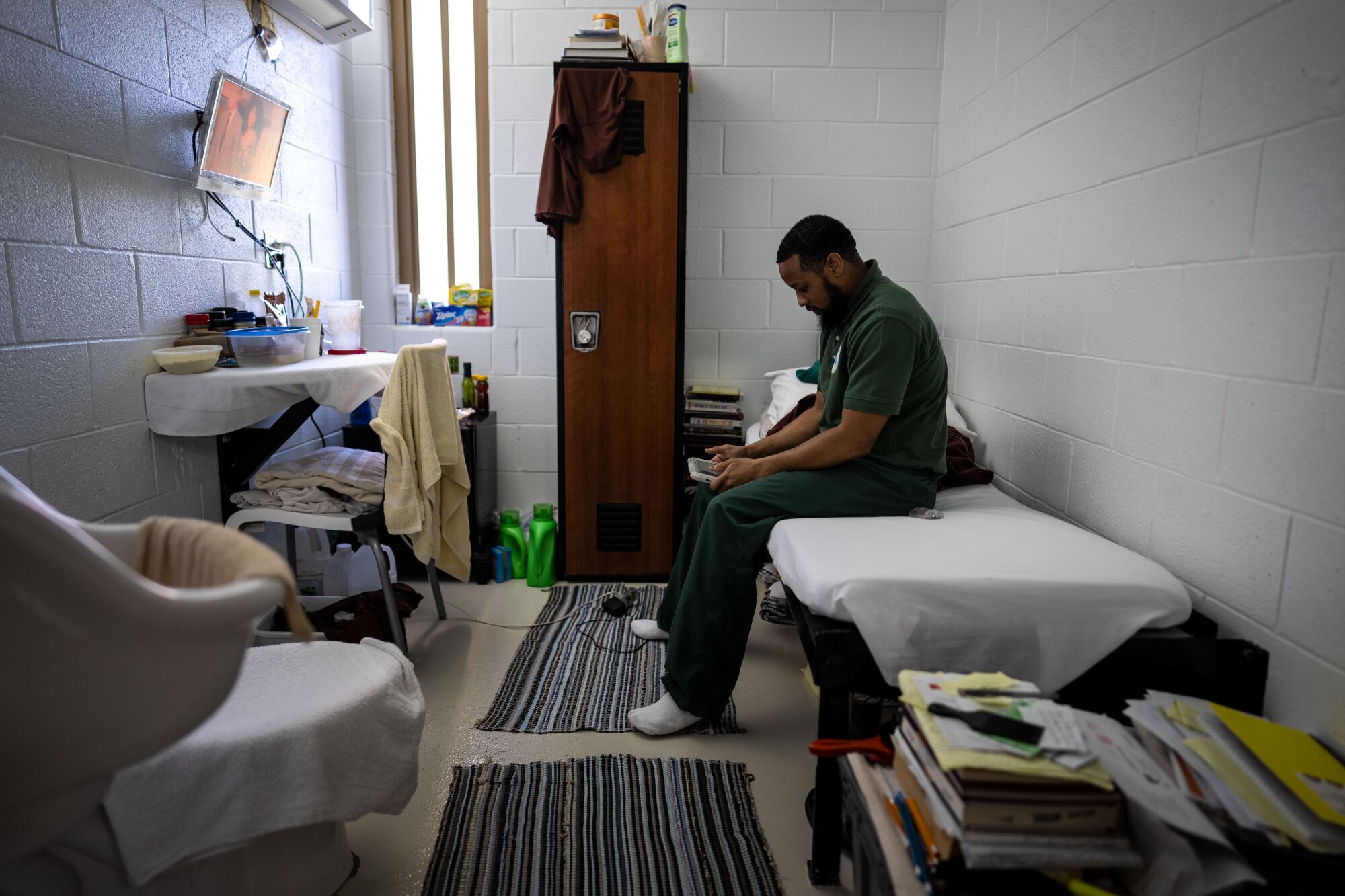 Inmate Joseph sits on the bed inside his cell in the "Little Scandinavia" unit.