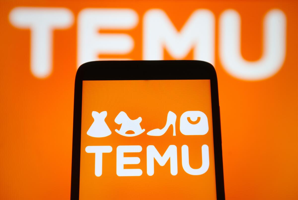 The Temu logo is seen on a smartphone and on a computer screen. 