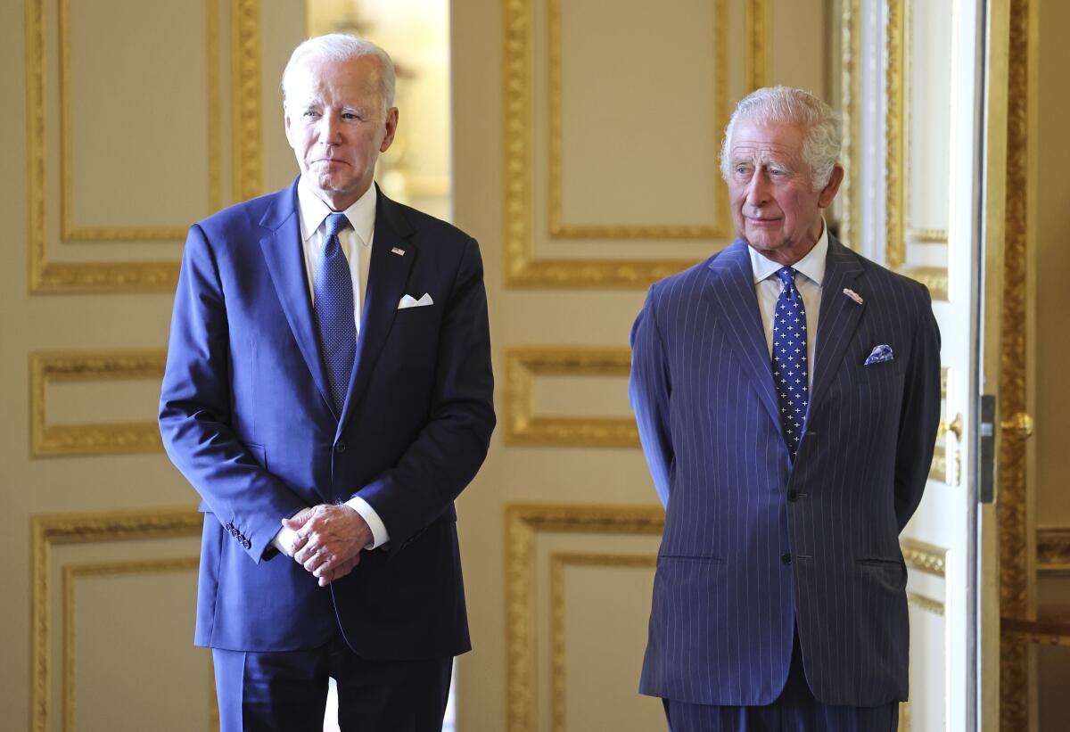 President Biden stands with Britain's King Charles III in Windsor Castle.