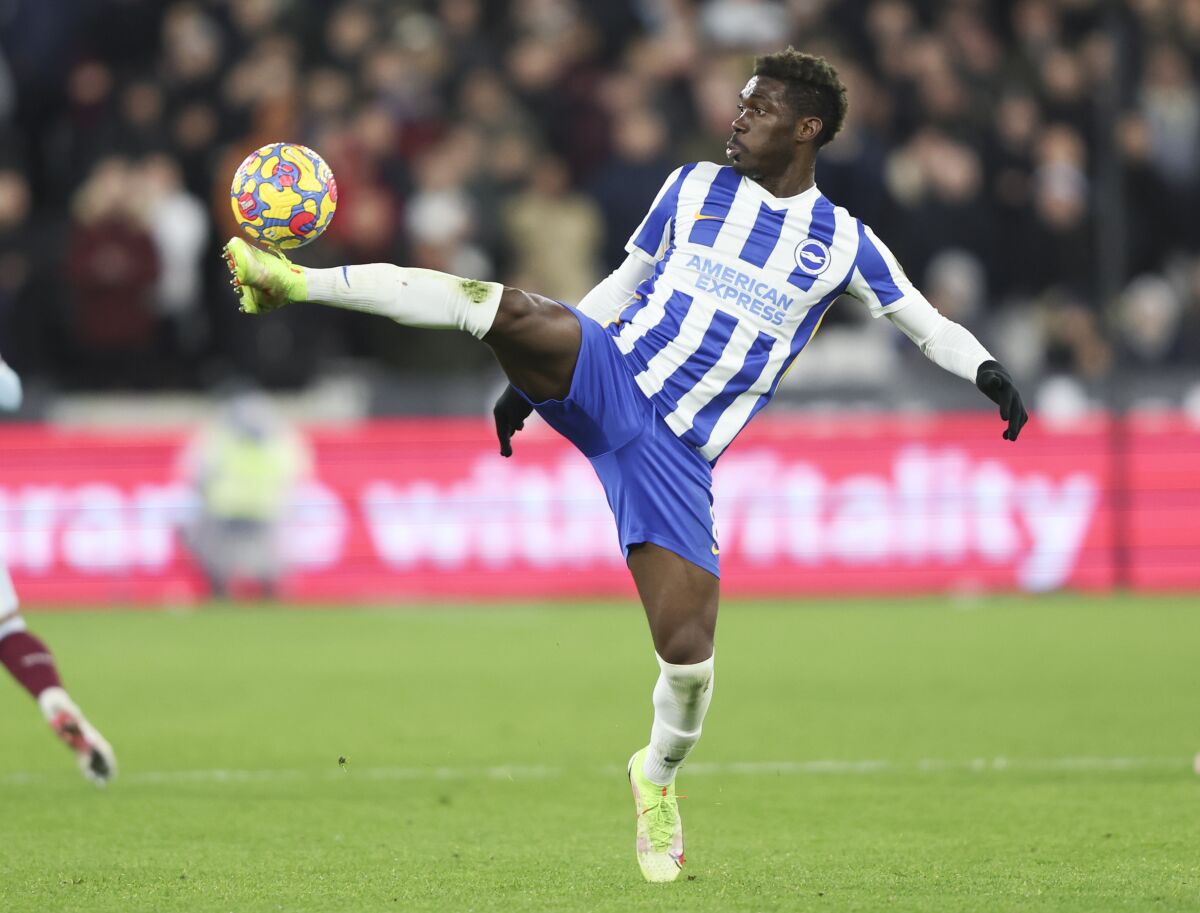 FILE - Brighton's Yves Bissouma controls the ball during the English Premier League soccer match between West Ham United and Brighton and Hove Albion in London, England, Wednesday, Dec. 1, 2021. Tottenham has strengthened its midfield options ahead of the team’s return to the Champions League by signing Mali international Yves Bissouma from fellow English Premier League club Brighton. Tottenham announced the signing without disclosing a fee. British media said Bissouma was costing an initial 25 million pounds. (AP Photo/Ian Walton, File)