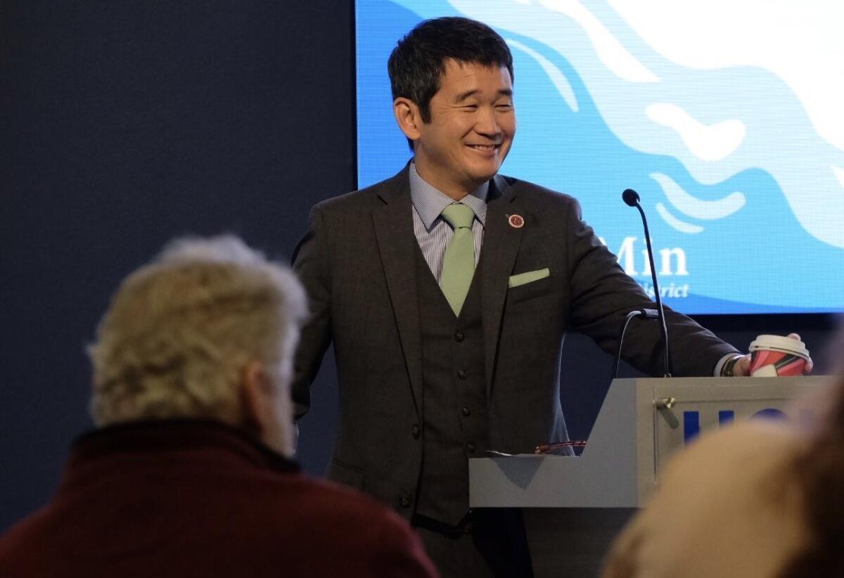 Sen. Dave Min stands at a lectern