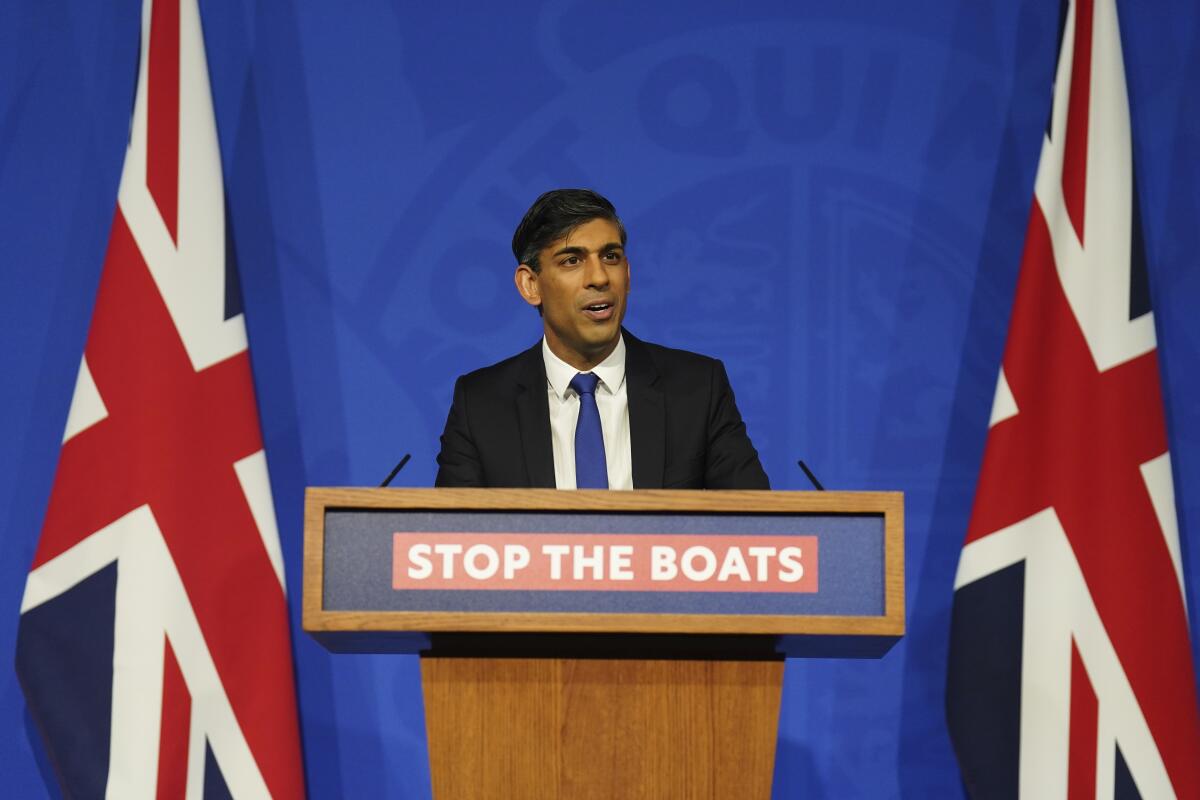 Britain's Prime Minister Rishi Sunak speaks at a lectern.