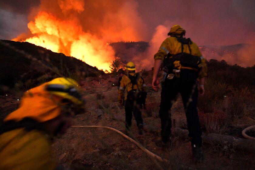 YUCAIPA, CALIFORNIA SEPTEMBER 1, 2020-Firefighters make they there way up a hill as the El Dorado Fire appriaches in Yucaipa Saturday.(Wally Skalij/Los Angeles Times)