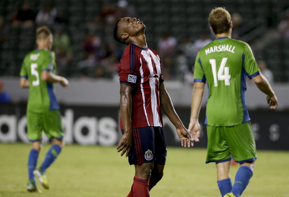 Chivas USA midfielder Carlos Alvarez, middle, reacts after missing a shot as Seattle Sounders midfielder Andy Rose, left, and Chad Marshallon Sept. 3 at StubHub Center.