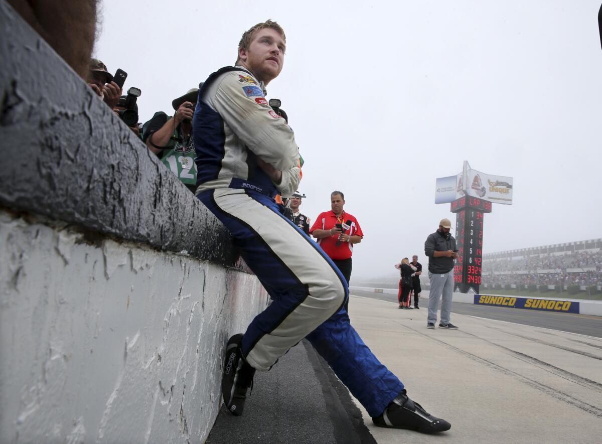 Chris Buescher (34) sits on pit wall waiting to be declared winner of the rain-shortened NASCAR Sprint Cup Pennsylvania 400 race on Aug. 1.