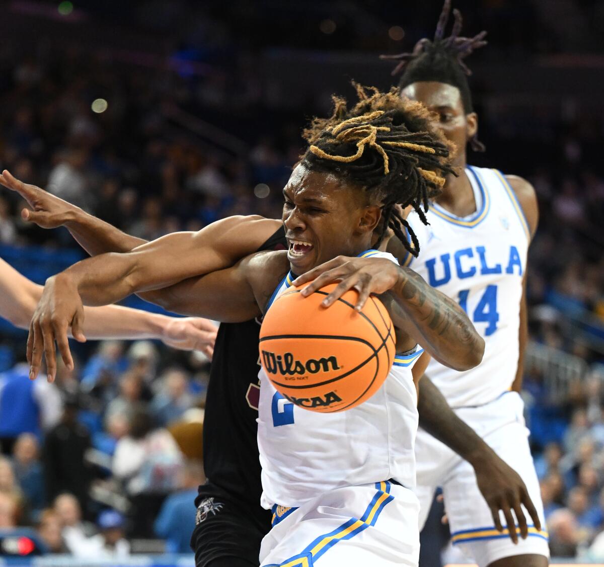 UCLA guard Dylan Andrews is fouled by Lafayette guard Devin Hines while driving to the basket at Pauley Pavilion.