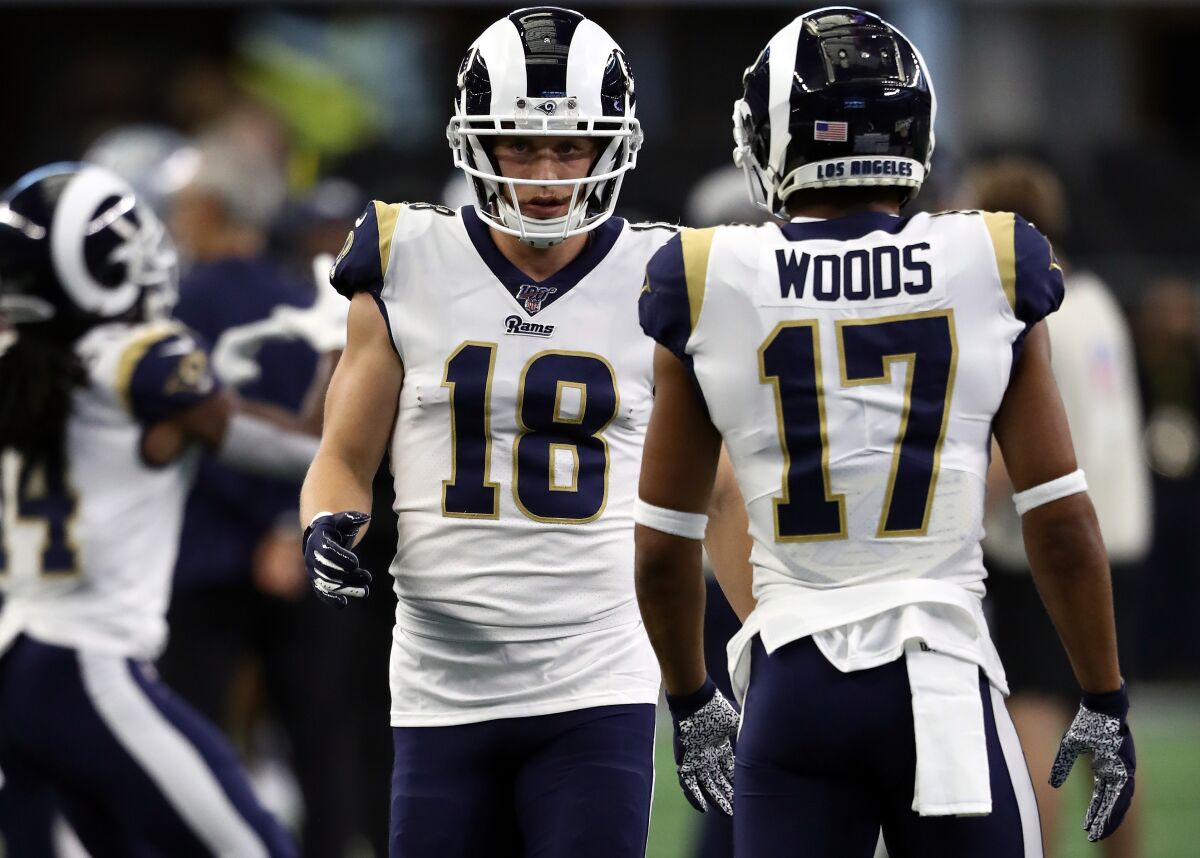 Rams receivers Cooper Kupp (18) and Robert Woods (17) warm up before a game against the Cowboys on Dec. 15 at AT&T Stadium.