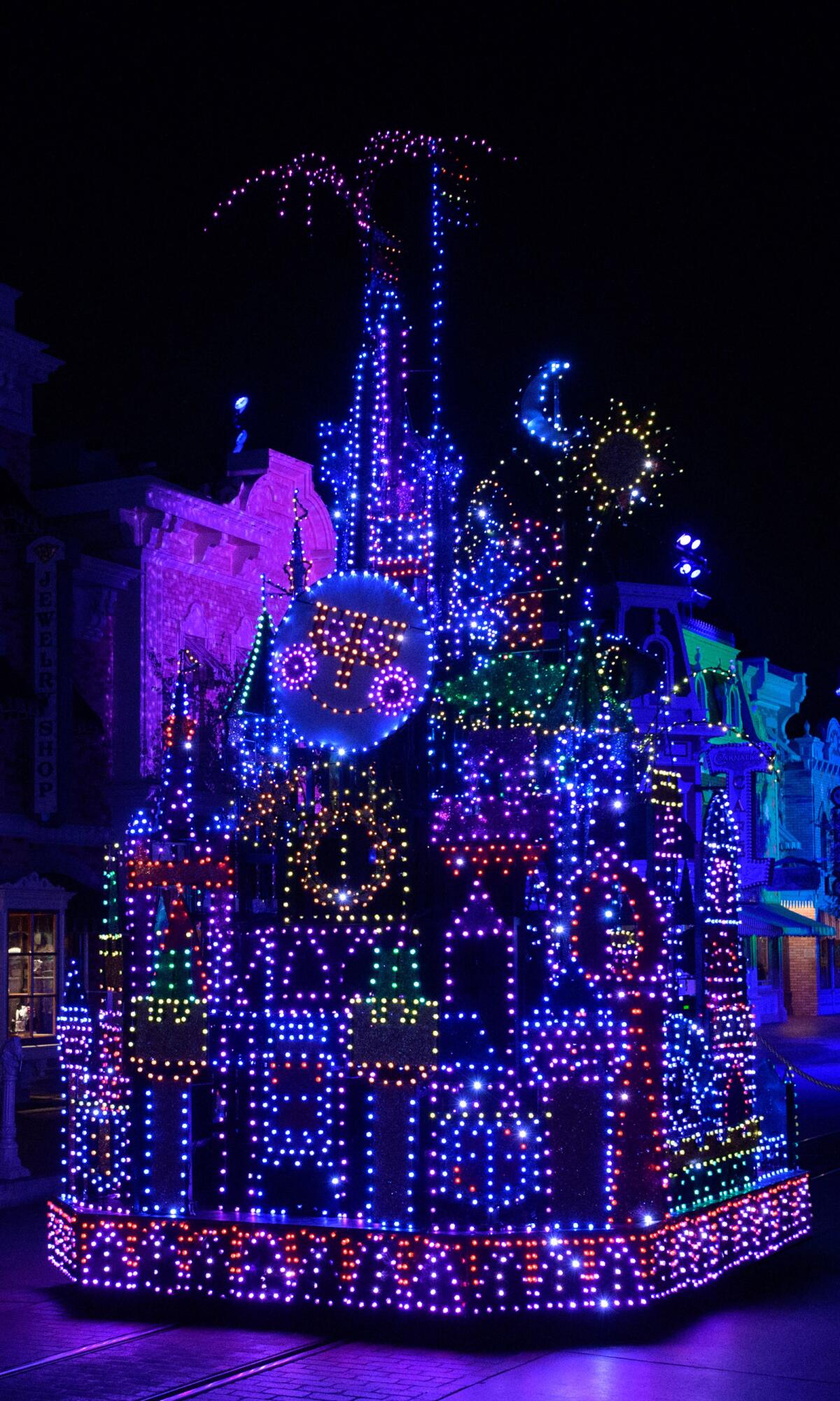 A float of a giant castle illuminated in the night