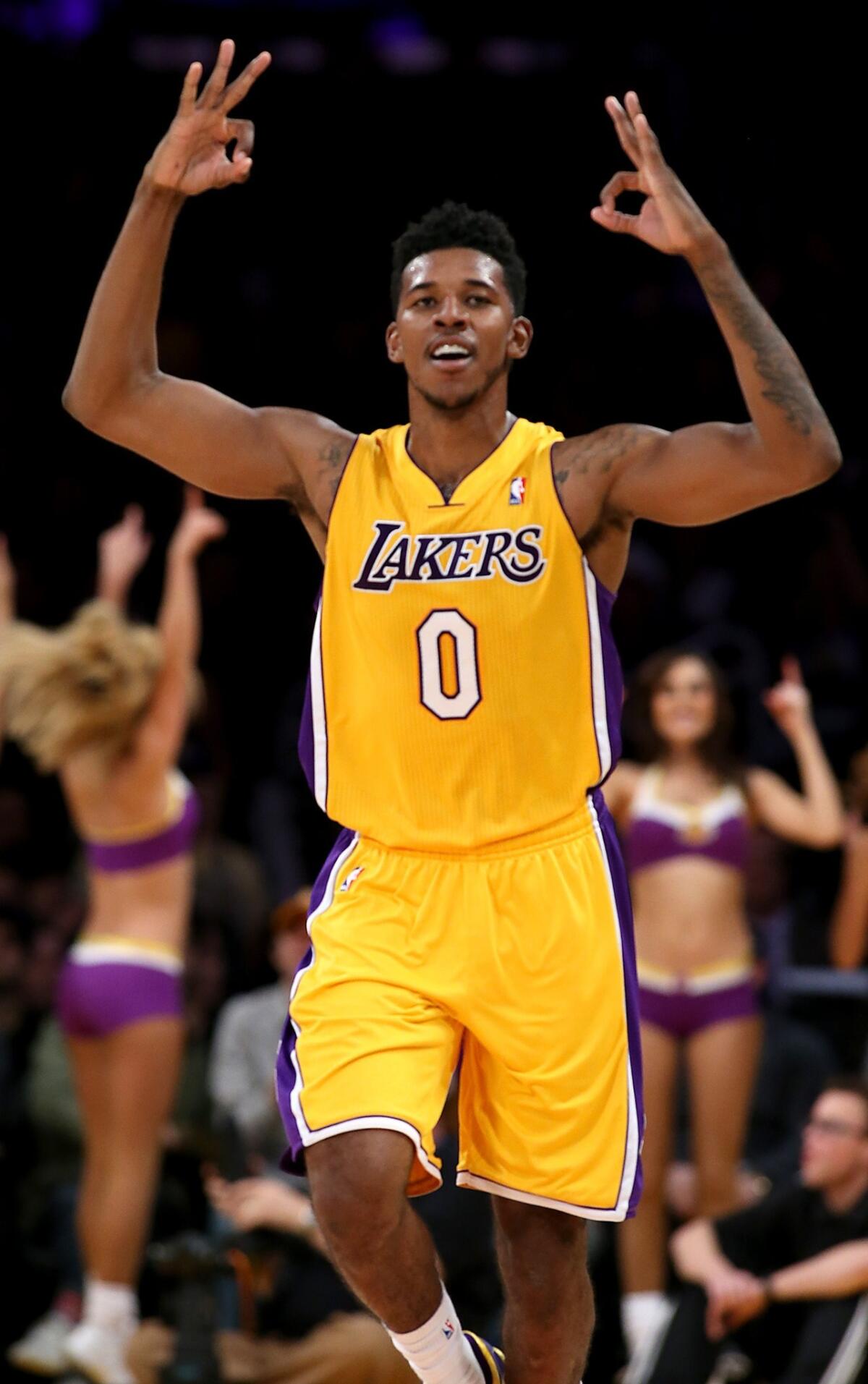 Lakers forward Nick Young celebrates after hitting a three-pointer against the Golden State Warriors in November.