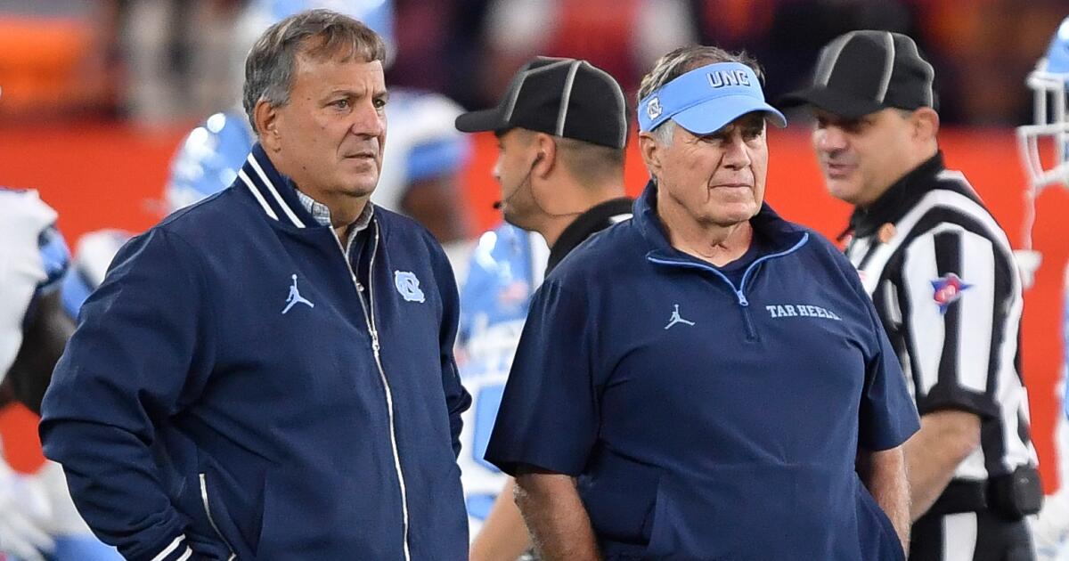 Photo: Los Angeles Times North Carolina head coach Bill Belichick, right, and general manager Michael Lombardi watch warm ups