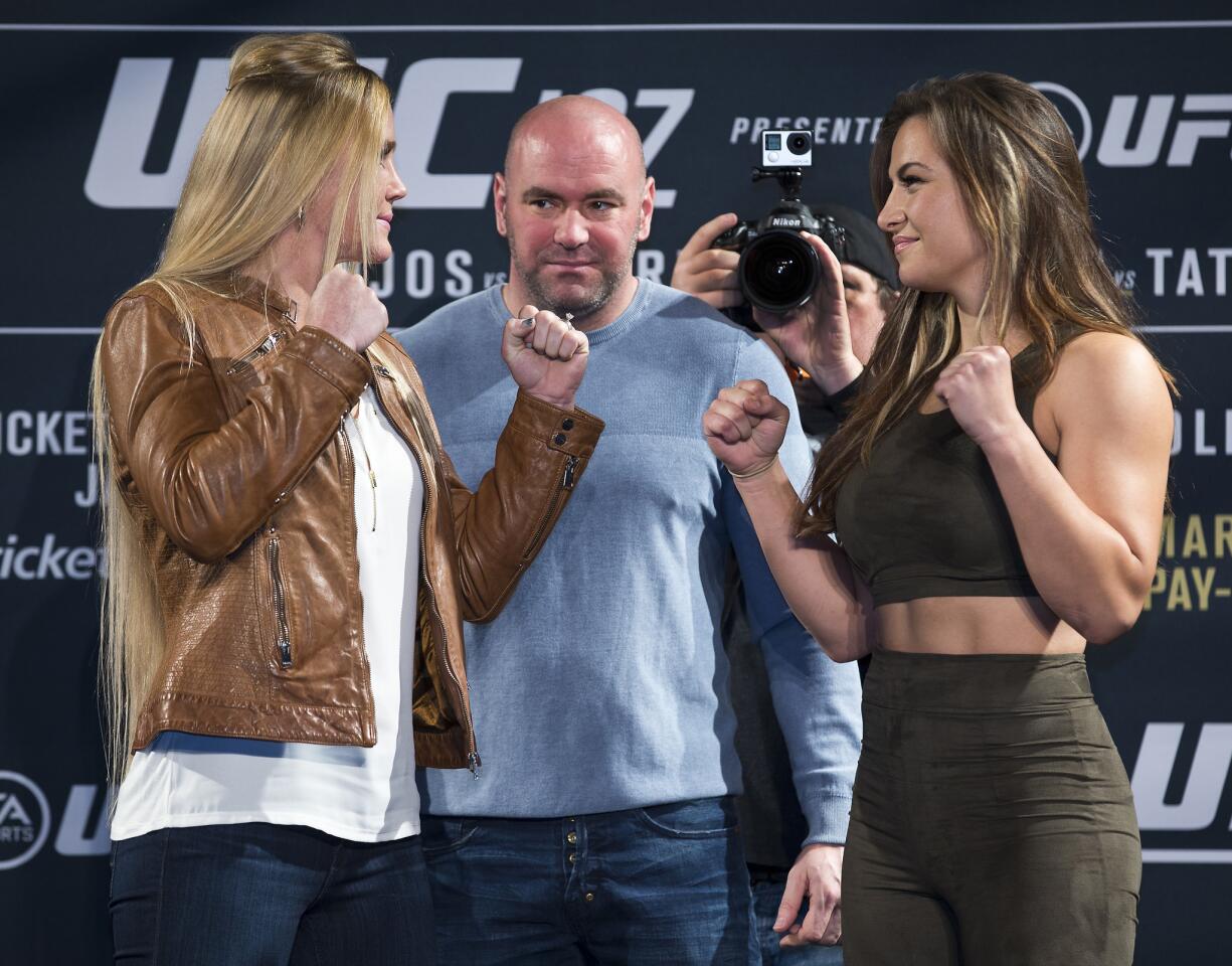 UFC 197 fighters Holly Holm, left, and Miesha Tate are faced-off by UFC President Dana White during a press conference at the MGM Grand in Las Vegas on Wednesday, Jan. 20, 2016. (L.E. Baskow/Las Vegas Sun via AP) LAS VEGAS REVIEW-JOURNAL; MANDATORY CREDITS